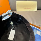 Louis Vuitton cap interior with black lining and adjustable strap, white hang tag.