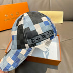 Louis Vuitton cap close-up with blue and black checkered fabric and textured brim edge.