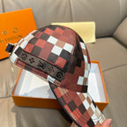 Louis Vuitton cap front panel with red, white, and black check pattern and brim