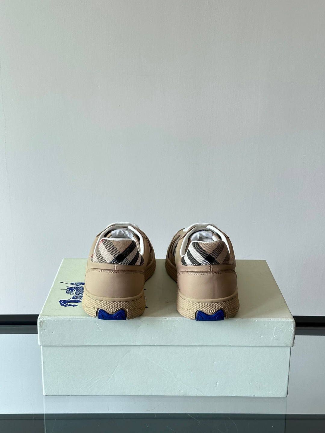 Beige low-top sneakers, white laces, back view with Burberry check detail