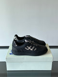 Black low-top sneakers with plaid panel and black lace-up design