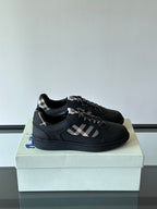 Black low-top sneakers with plaid panel and black lace-up design