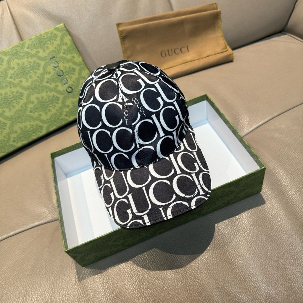 Gucci cap with black-and-white GG pattern, curved brim and button top