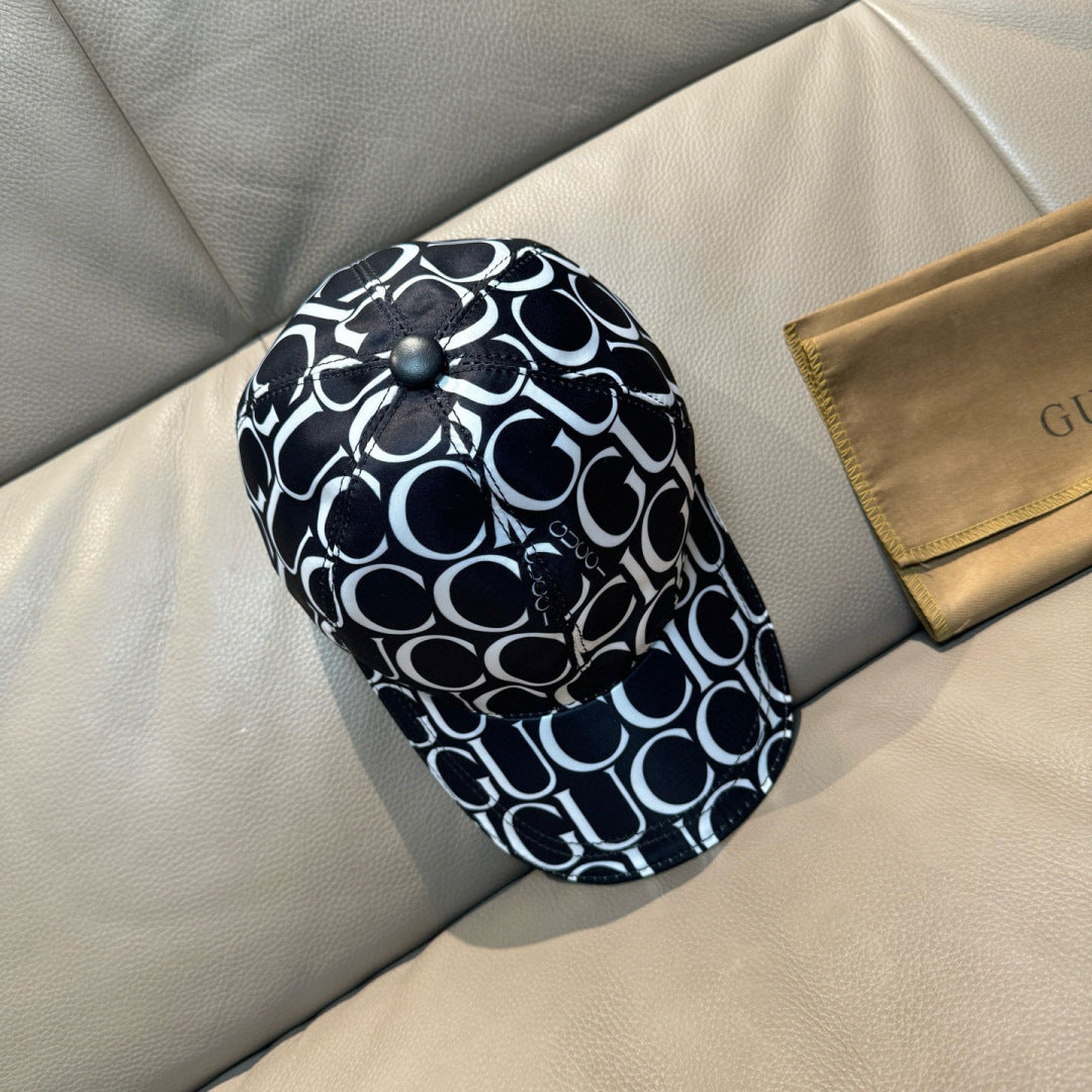 Gucci cap with black-and-white GG pattern and button detail, curved brim