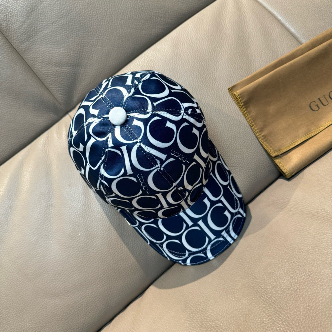 Gucci cap in navy and white with GG monogram print, front button detail, curved brim.