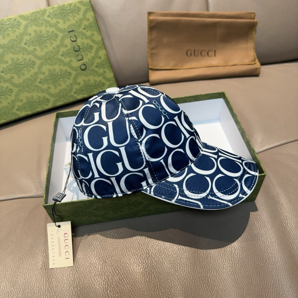 Gucci cap with navy and white GG monogram, curved brim, visible side stitching detail.