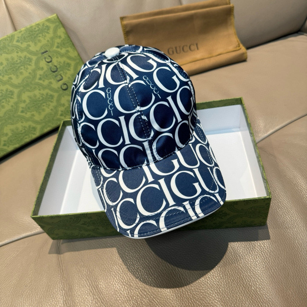 Gucci cap in navy with white GG monogram pattern, curved brim and adjustable back.