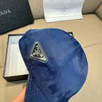 Blue satin cap with Prada triangular logo patch on side panel.