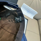 Blue cap with adjustable strap and interior label.