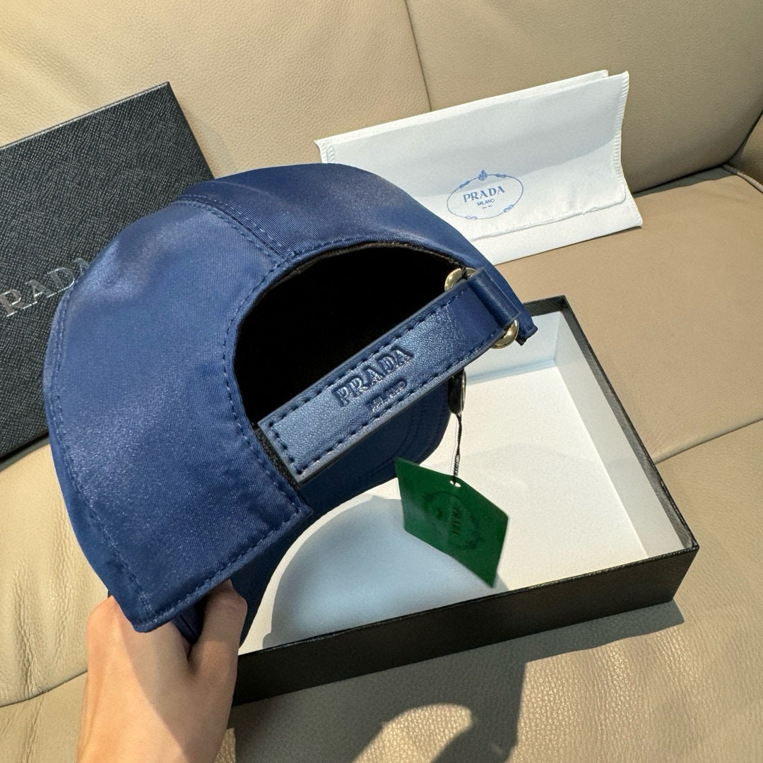Blue cap interior view with adjustable strap and Prada logo fabric tab.