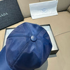Blue satin baseball cap close-up of top button and seam lines.