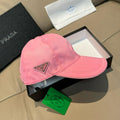 Pink baseball cap with Prada triangular logo patch and curved brim
