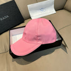 Pink baseball cap with curved brim and embroidered Prada logo triangle