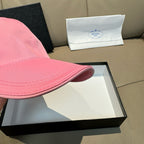 Pink baseball cap brim close-up with stitched trim
