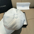 Prada cap in white satin with button top and fan-style stitching