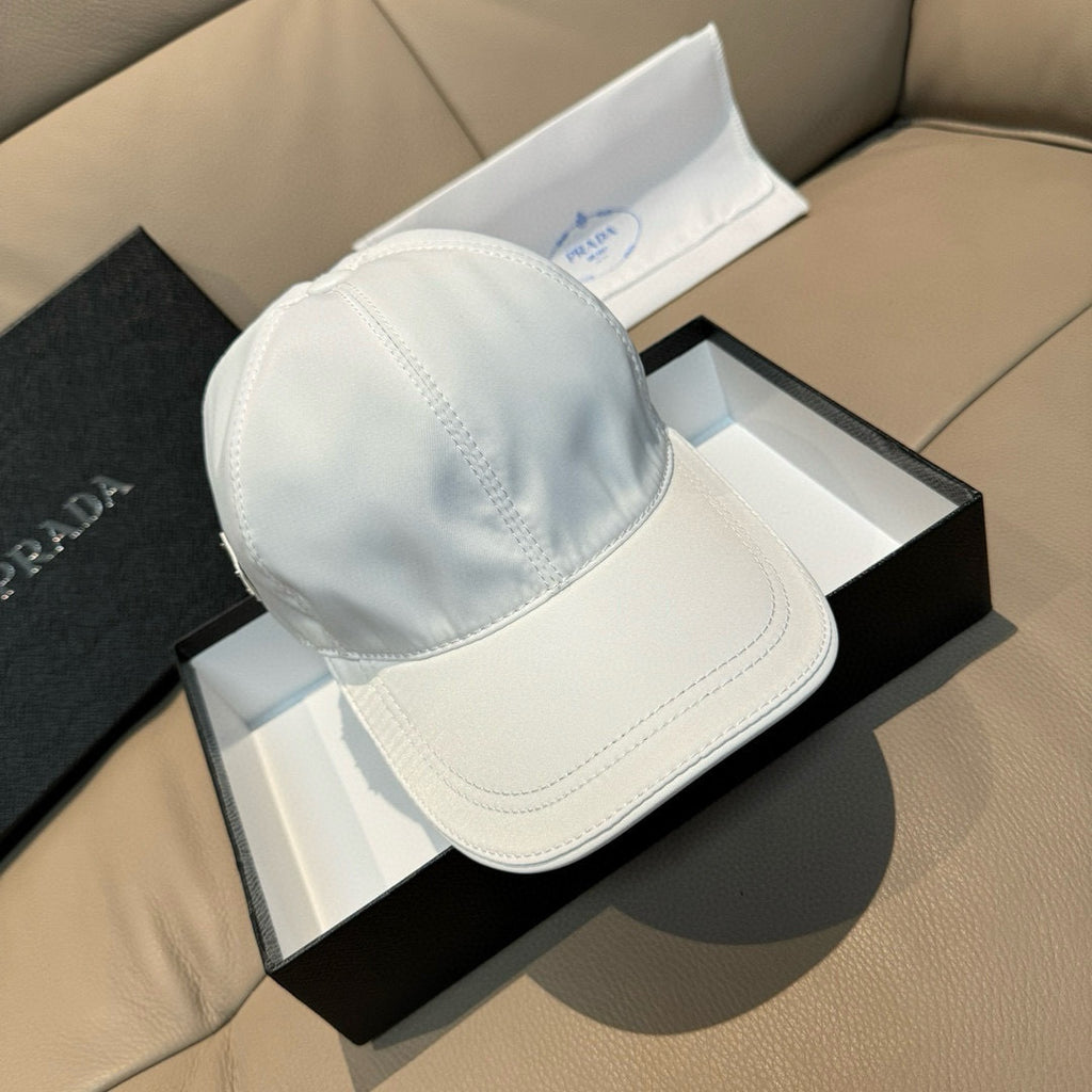 Prada cap in white satin with curved brim and stitched crown seams