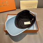 Louis Vuitton denim cap in light blue, interior shown with black lining inside.