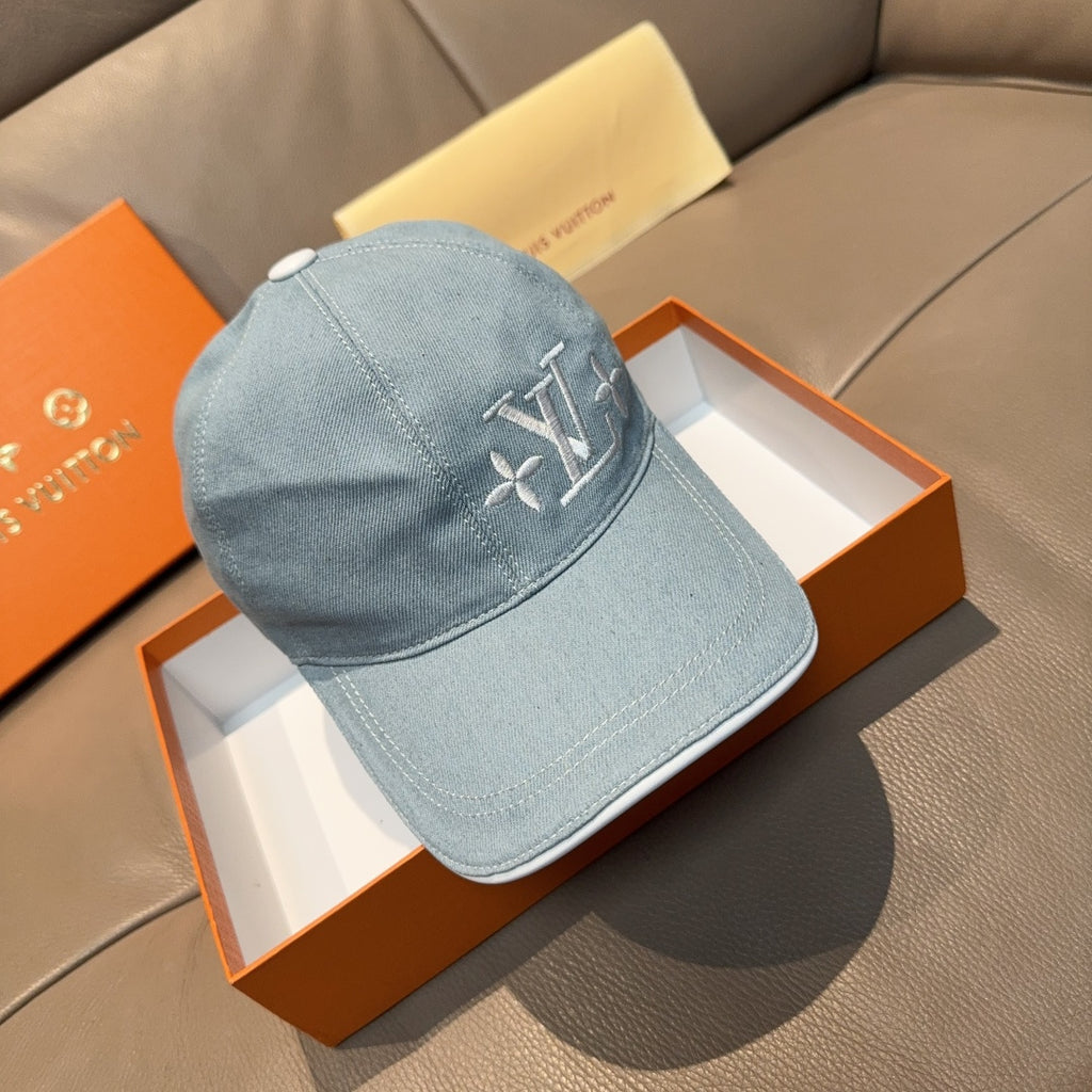 Louis Vuitton denim baseball cap in light blue with embroidered LV logo on front.