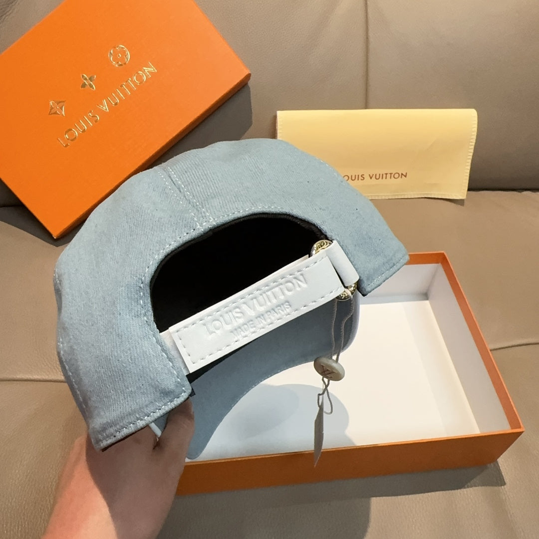 Louis Vuitton denim baseball cap in light blue with adjustable white strap near opening.