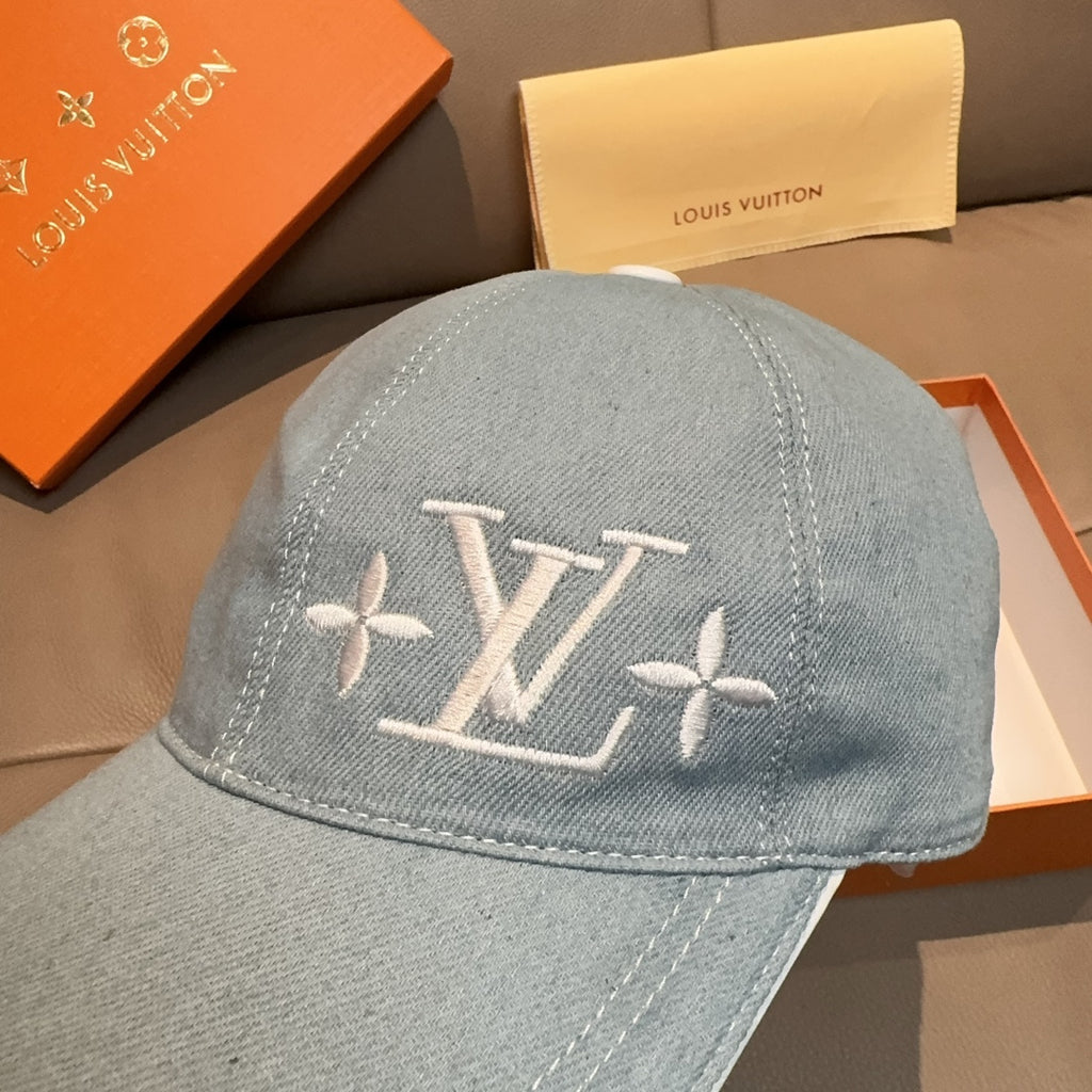 Louis Vuitton denim baseball cap in light blue with large LV logo embroidery on crown.