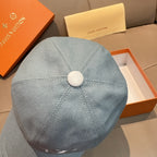 Louis Vuitton denim baseball cap in light blue, back view with round top button.