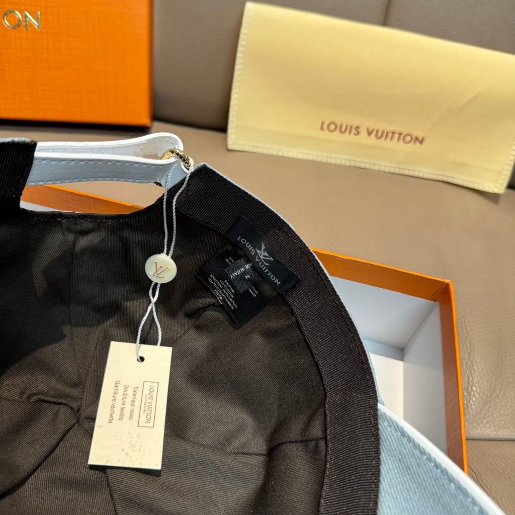 Louis Vuitton cap with black fabric lining and dangling tag, inside view.