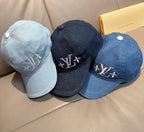 Set of three Louis Vuitton denim caps: light blue, dark navy, and medium blue with logos