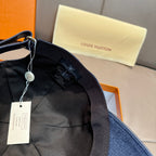 Louis Vuitton denim cap interior view with black lining and hanging tags; dark blue brim