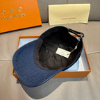Louis Vuitton denim cap with dark blue brim and black interior lining; label visible