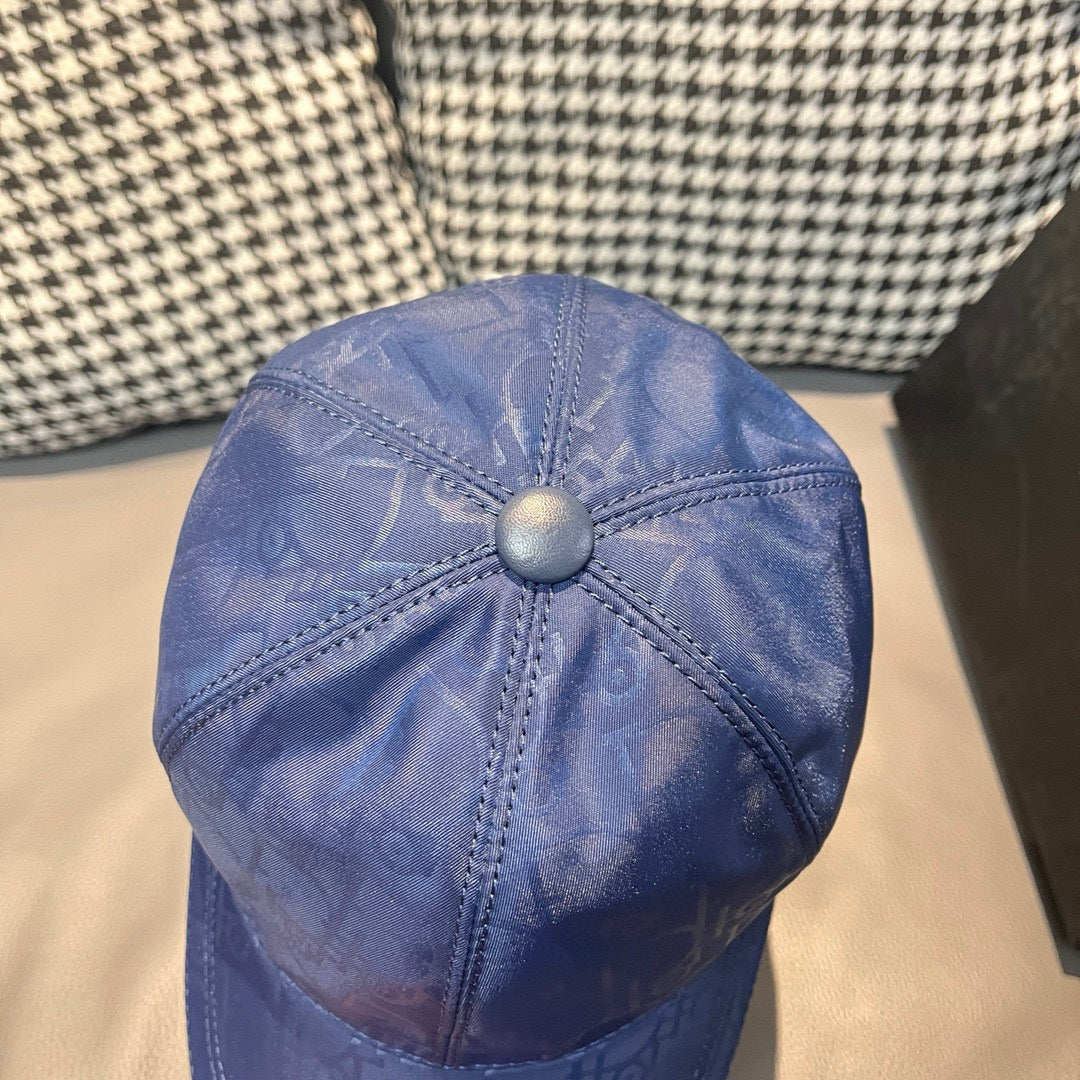 Dior cap top in blue with stitched seams and round button on crown.