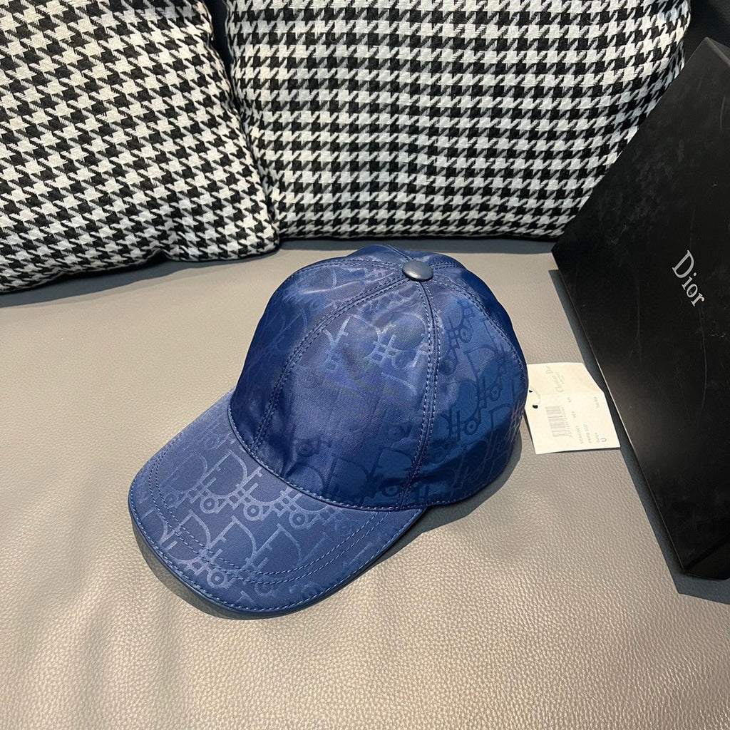 Dior cap in blue with curved brim and tonal monogram pattern, adjustable snap.