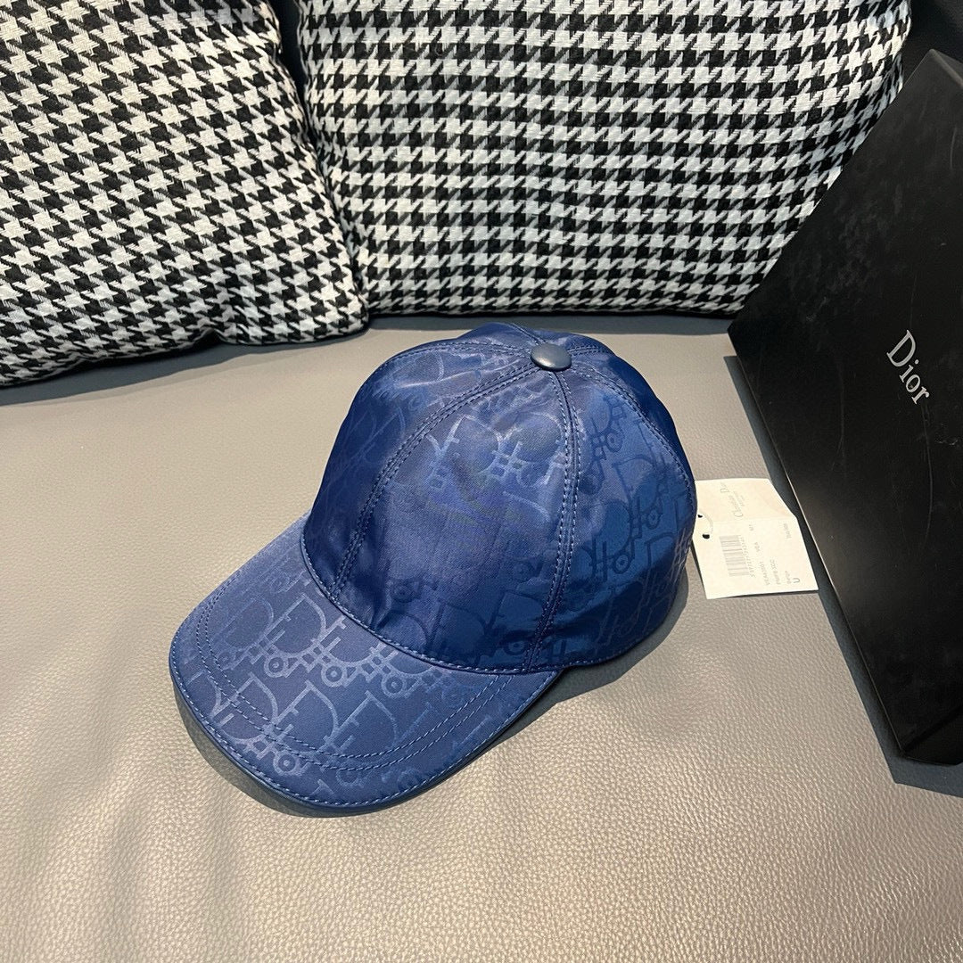 Dior cap in blue with curved brim and tonal monogram pattern, adjustable snap.