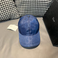 Dior cap in blue with subtle monogram pattern and metal button on top.