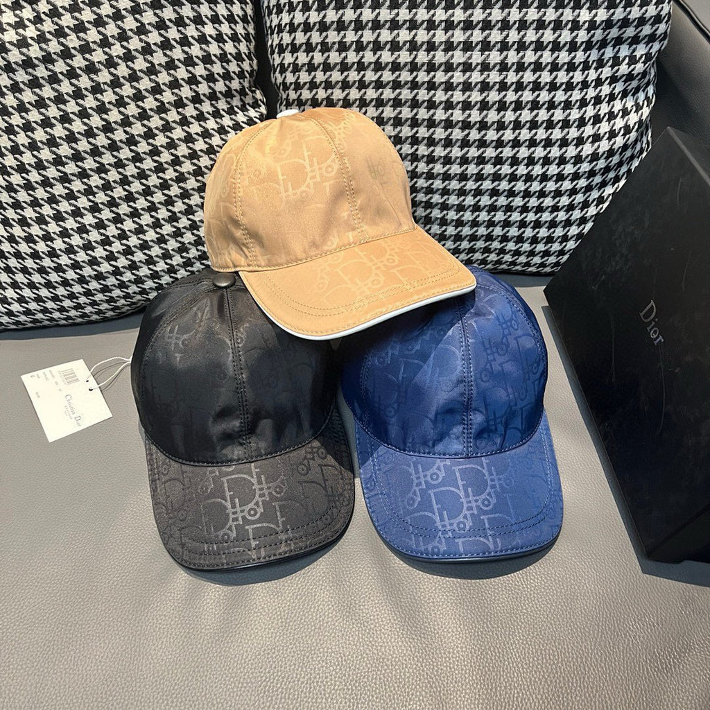 Dior cap set with blue, black, and beige monogram caps, each with curved brim.
