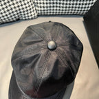 Dior cap close-up with round button crown and monogram print on dark fabric