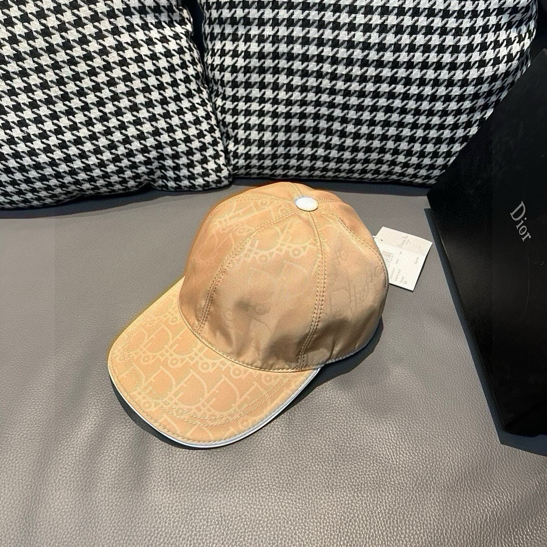 Beige monogram baseball cap with curved brim and stitched panel seams