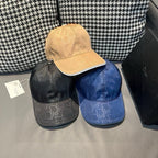 Set of four monogram baseball caps: beige, black, gray, and navy with curved brims