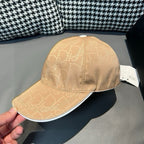 Beige monogram baseball cap close-up with top button and curved brim edge