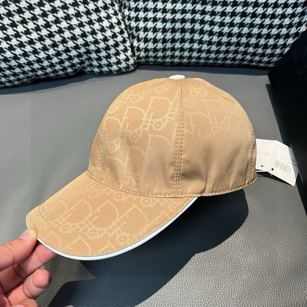 Beige monogram baseball cap close-up with top button and curved brim edge