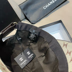 Chanel cap interior view with black lining and adjustable strap, tags visible