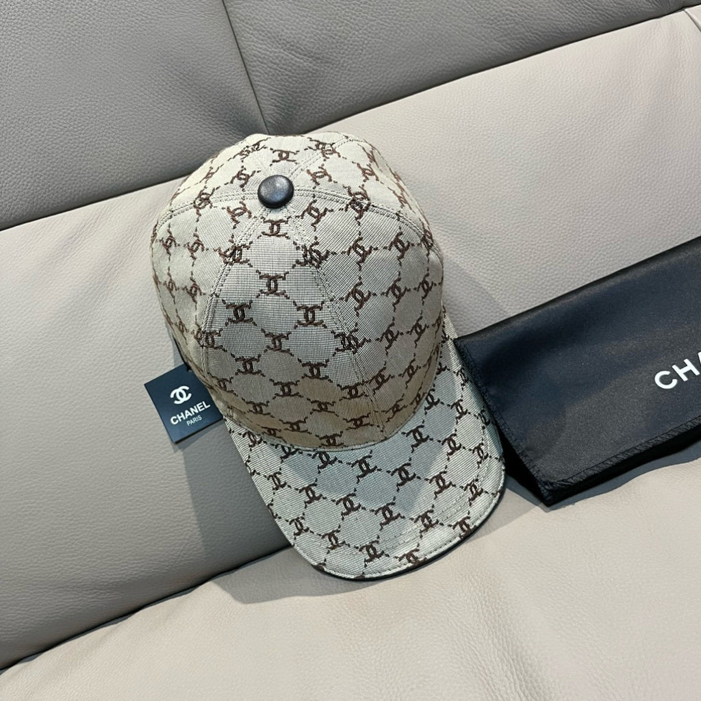 Chanel baseball cap in beige monogram canvas with dark button and curved brim, side view