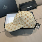 Beige monogram baseball cap with black adjustable strap and curved brim; top button