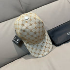 Beige baseball cap with repeating monogram print and white top button; curved visor