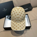 Beige baseball cap with tan monogram pattern and small top button; curved brim