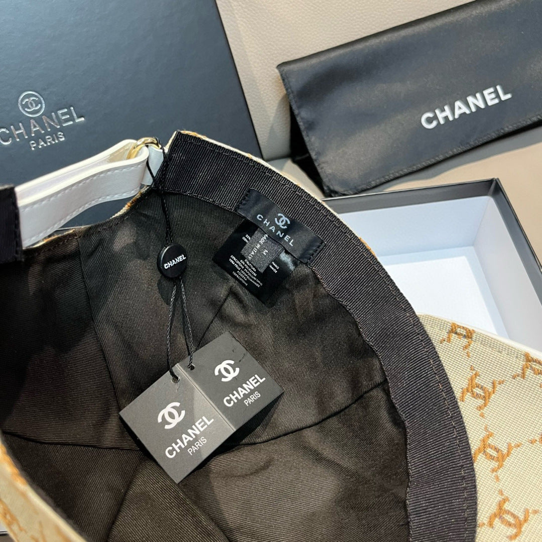 Beige monogram baseball cap with black adjustable strap and CHANEL tags