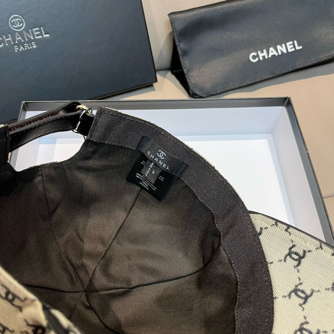 Chanel cap with black adjustable strap and logo label on beige monogram fabric