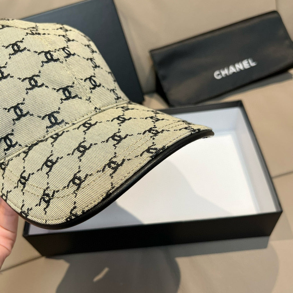 Chanel baseball cap side view in beige canvas with black monogram print, curved brim