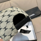 Chanel cap with beige logo fabric and black leather patch, side opening