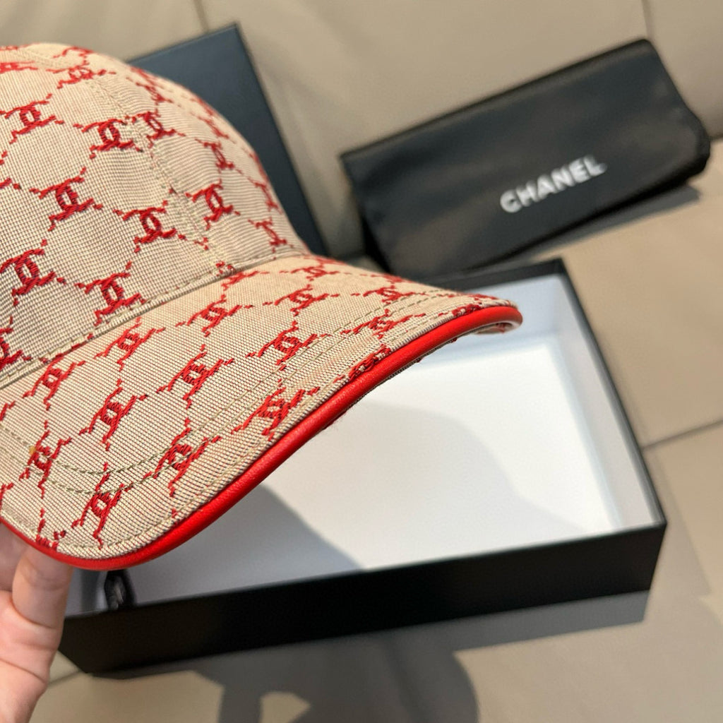 Baseball cap brim detail with red edge stitching on logo-pattern fabric