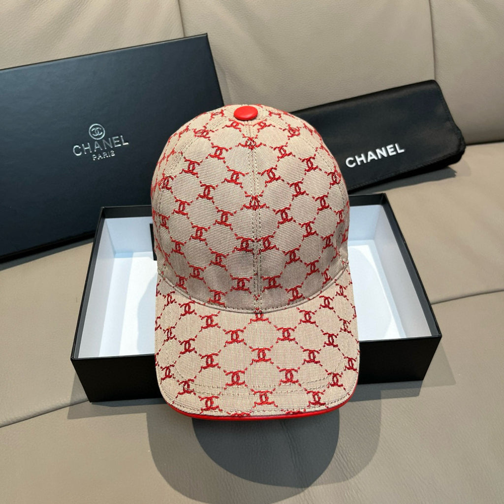 Designer logo baseball cap with red trim and red button on cream fabric